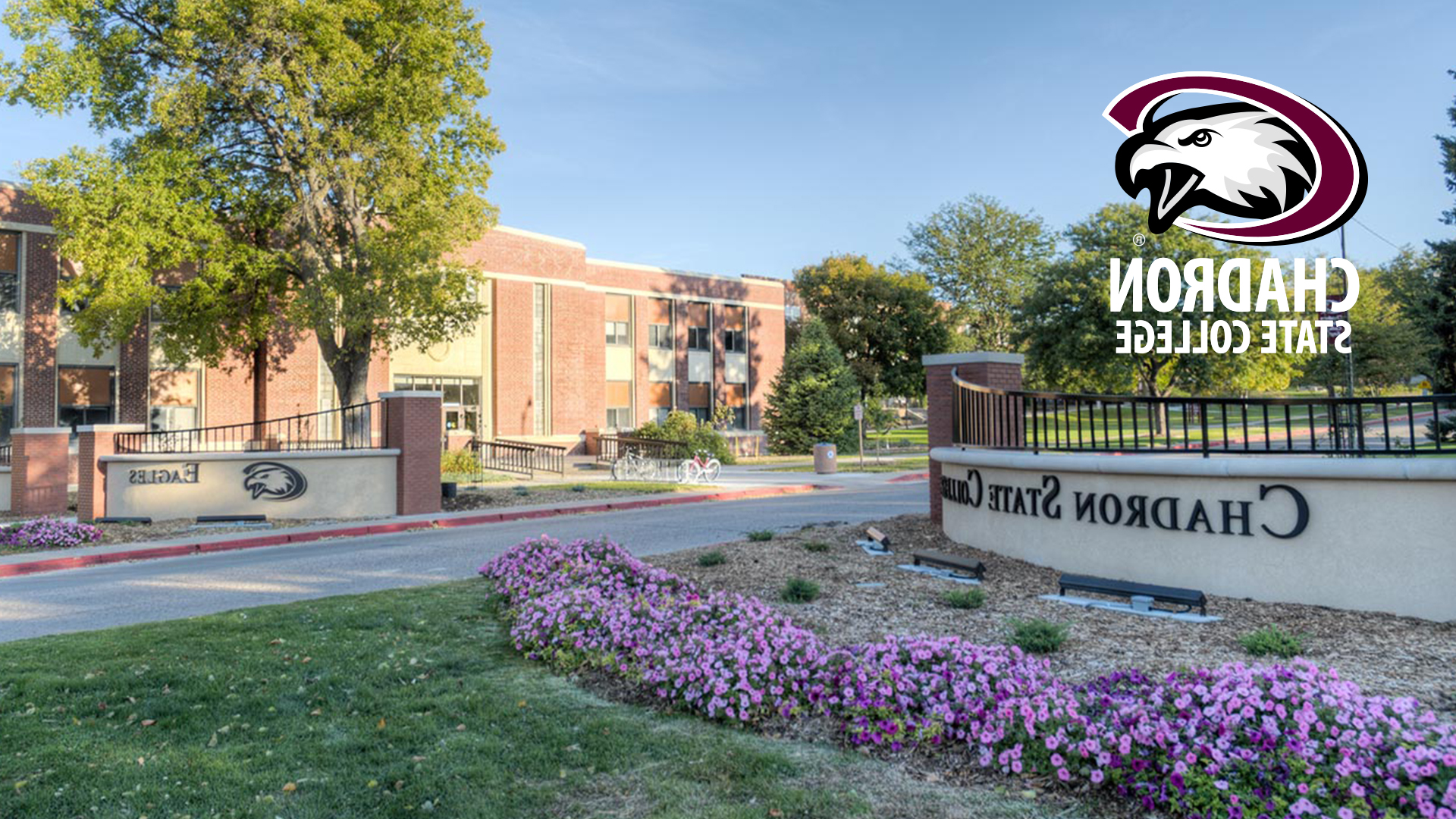 An image of the entry to Chadron State College from 10th & Main St. CSC Eagle logo with Chadron State College words underneath in white lettering. Left brown wall says Chadron State College. Right wall says Eagles.